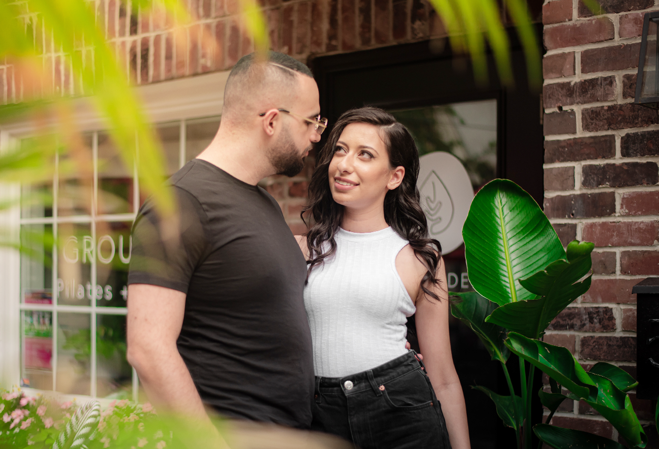 Engaged couple walking together through Village Square in Burlington